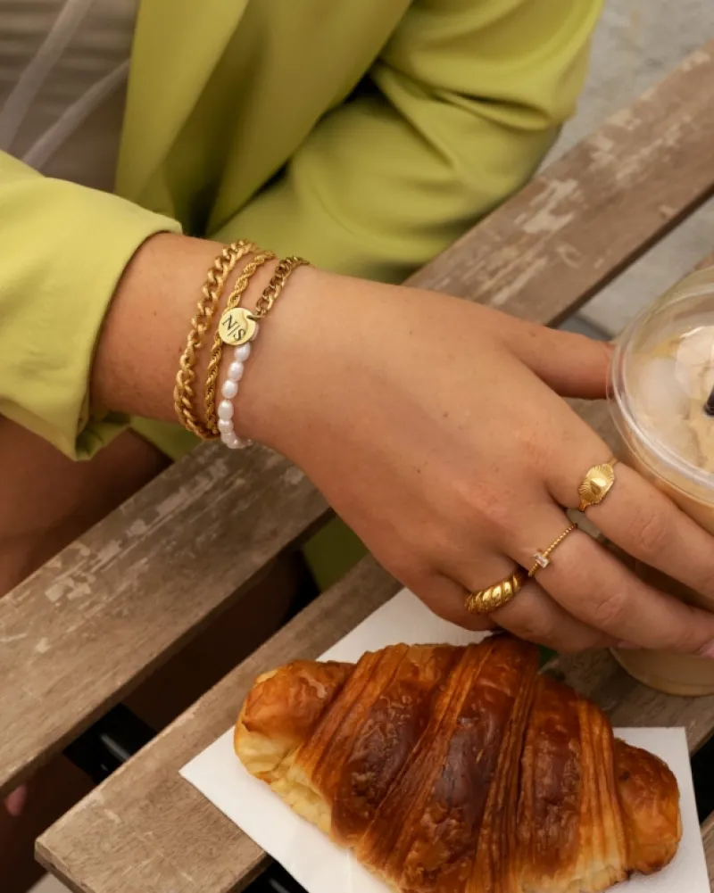 Finaste Schakelarmband gedraaid goudkleurig Best